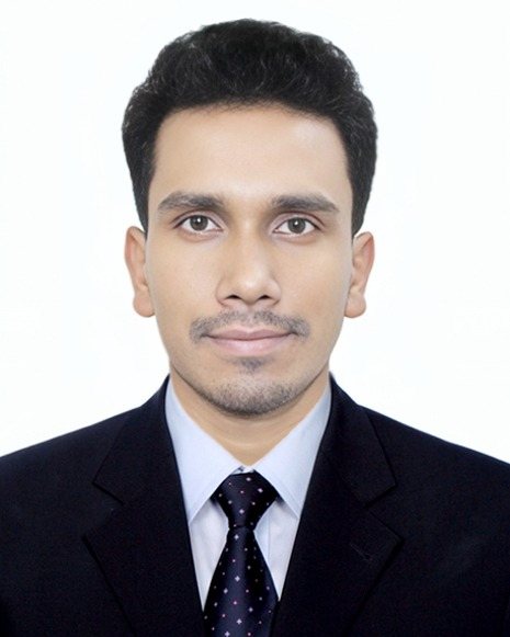 Portrait of Kamrul Hassan in a dark suit and tie